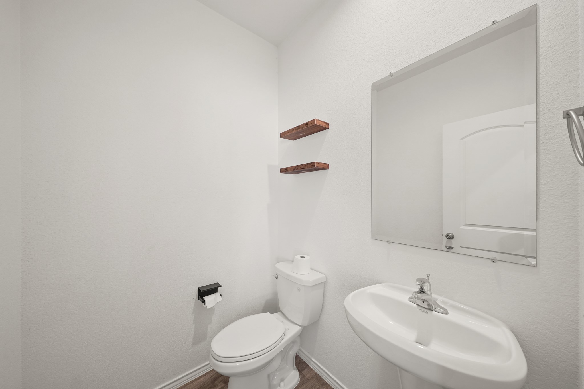 2406 Silver Prairie Ln Spring Spring, TX 77373 - Photo 16 of 30 a bathroom with a sink a toilet and a mirror