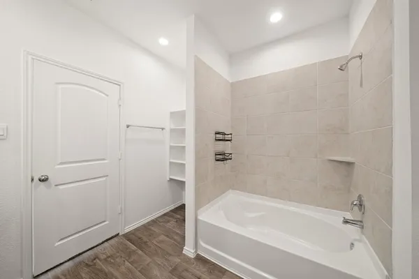 a bathroom with a bathtub and a shower