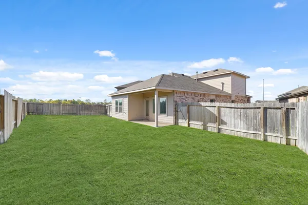 a view of a house with a yard and sitting area