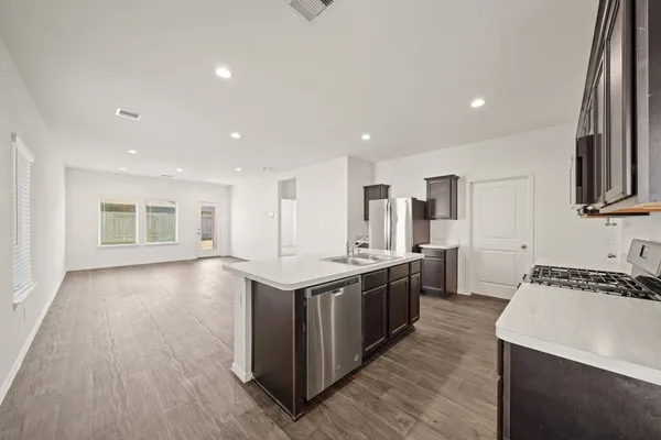 a kitchen with stainless steel appliances granite countertop a stove and a sink