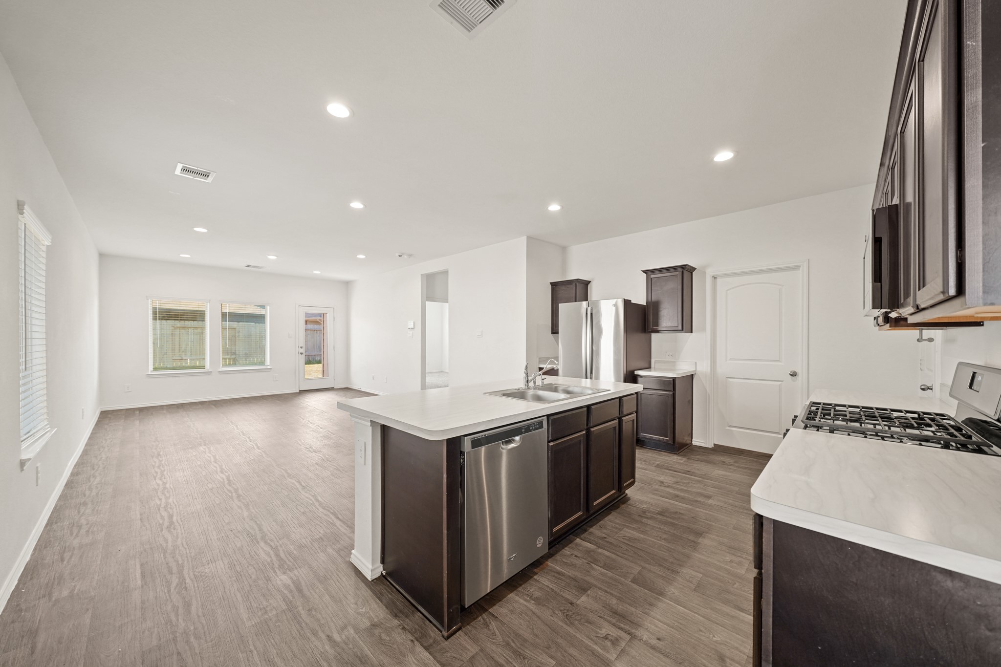 2406 Silver Prairie Ln Spring Spring, TX 77373 - Photo 5 of 30 a kitchen with stainless steel appliances granite countertop a stove and a sink