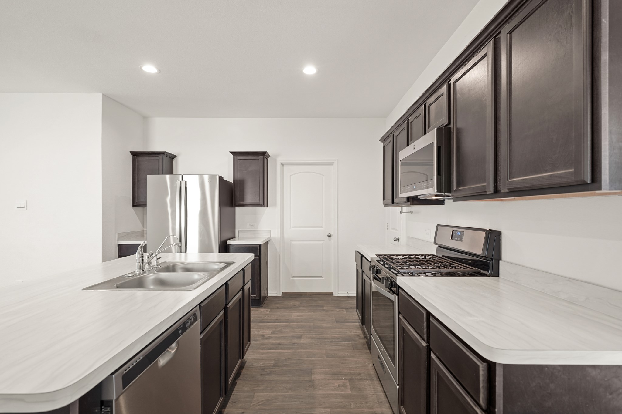 2406 Silver Prairie Ln Spring Spring, TX 77373 - Photo 6 of 30 a kitchen with stainless steel appliances granite countertop a sink stove and refrigerator