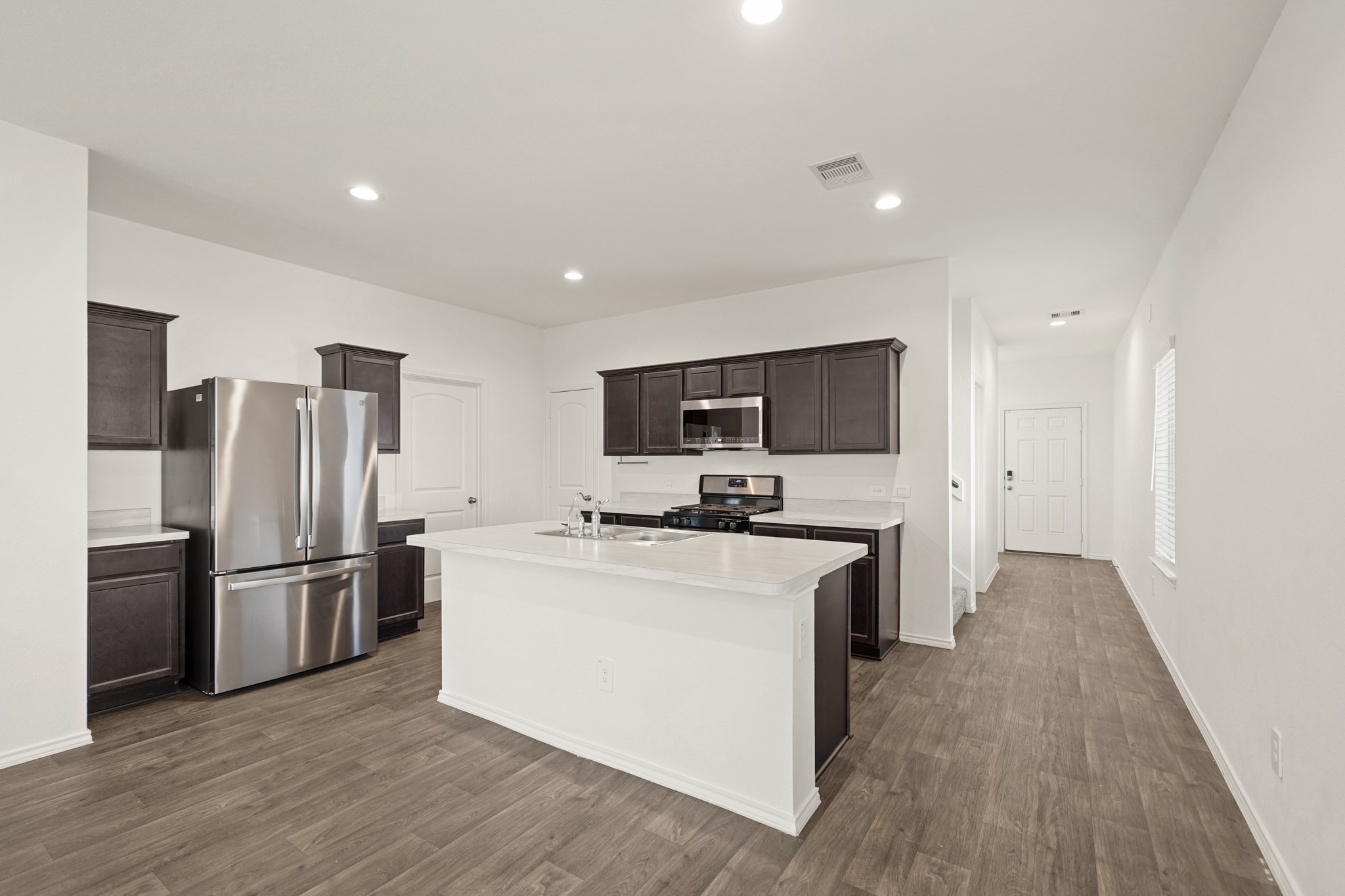 2406 Silver Prairie Ln Spring Spring, TX 77373 - Photo 7 of 30 a kitchen with stainless steel appliances a refrigerator stove a sink and a oven