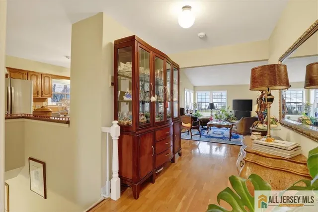 a living room with fireplace furniture and a large window