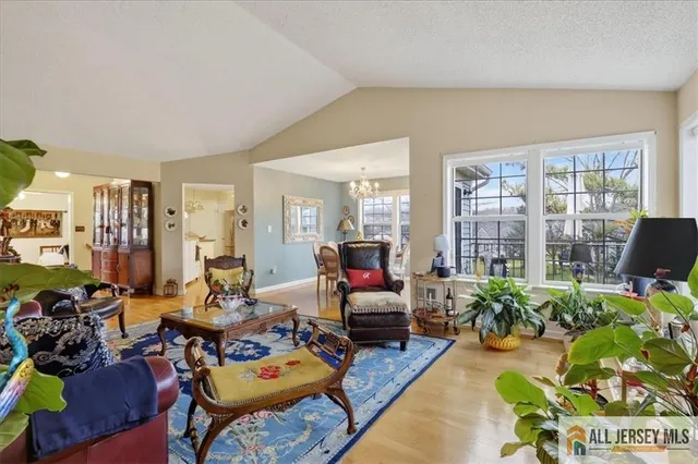 a living room with furniture and a floor to ceiling window