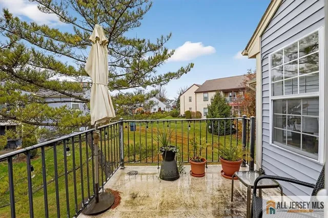 a view of a balcony with lake view and a potted plant