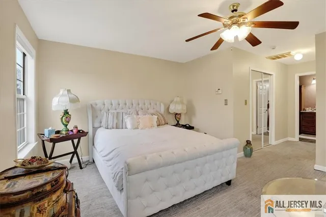 a bedroom with a bed and ceiling fan