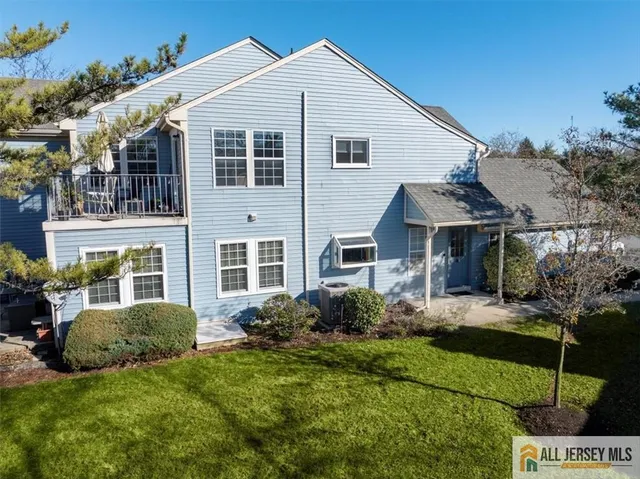 a view of a house with a small yard and plants