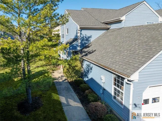 a aerial view of a house with a yard and potted plants