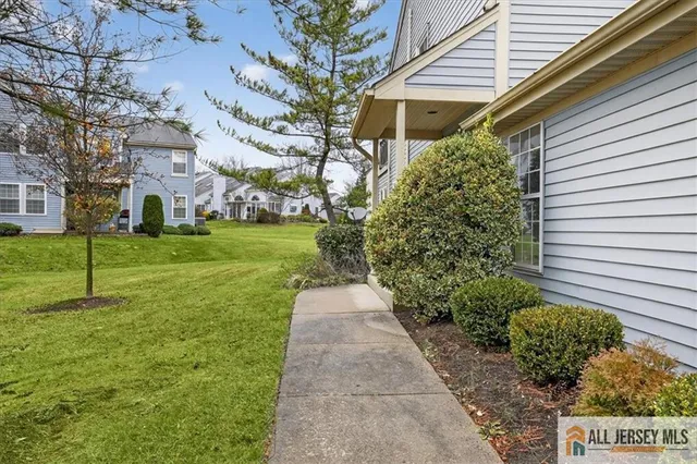 a pathway of a house with a yard