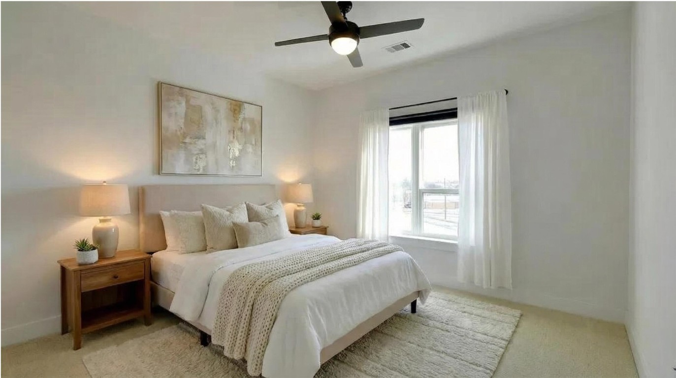 2220 Webberville Road, Unit 303 Austin, TX 78702 - Photo 3 of 14 a bedroom with a bed and a window