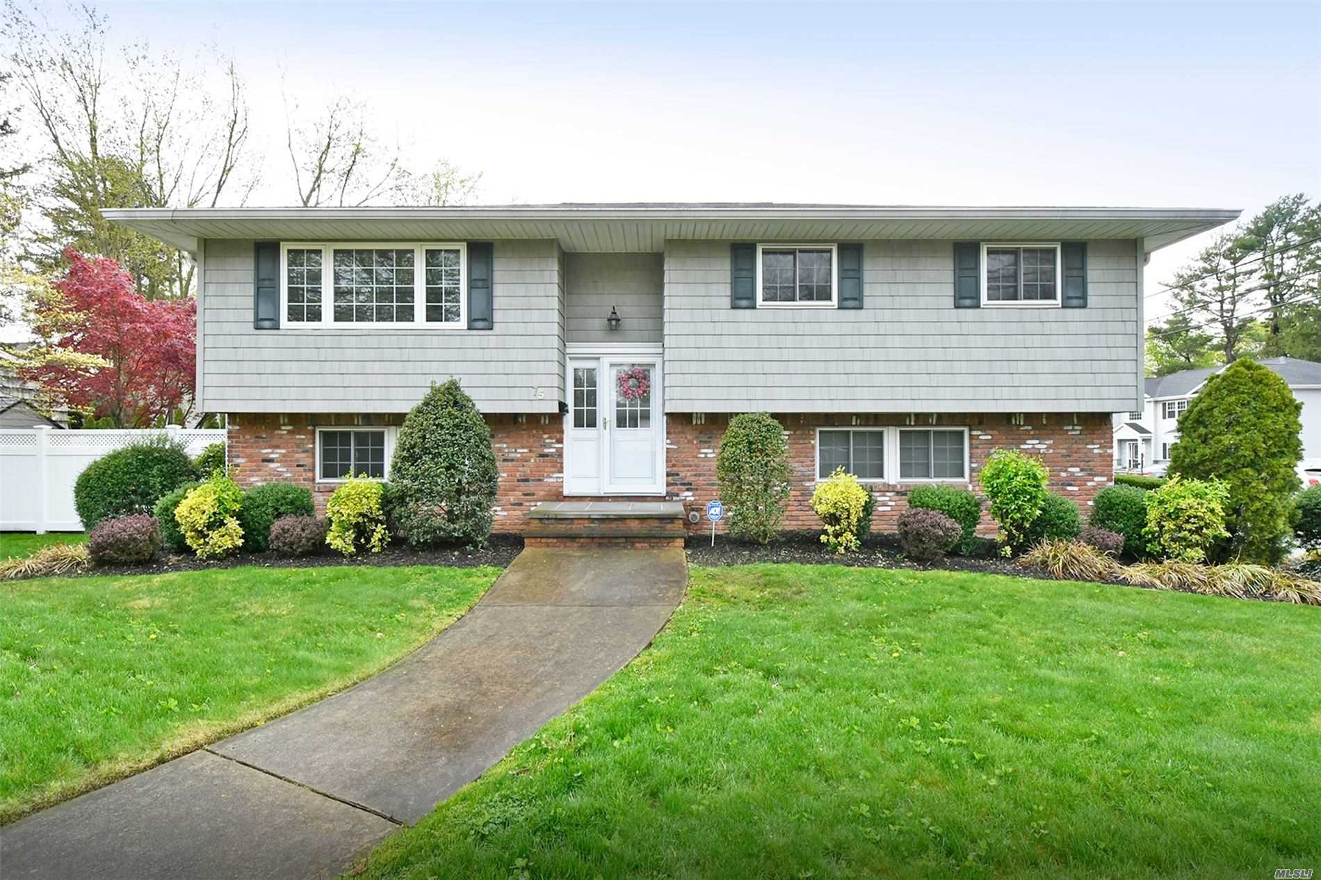 75 Split Rock Road Syosset, NY 11791 - Photo 1 of 1 a front view of a house with a yard and porch