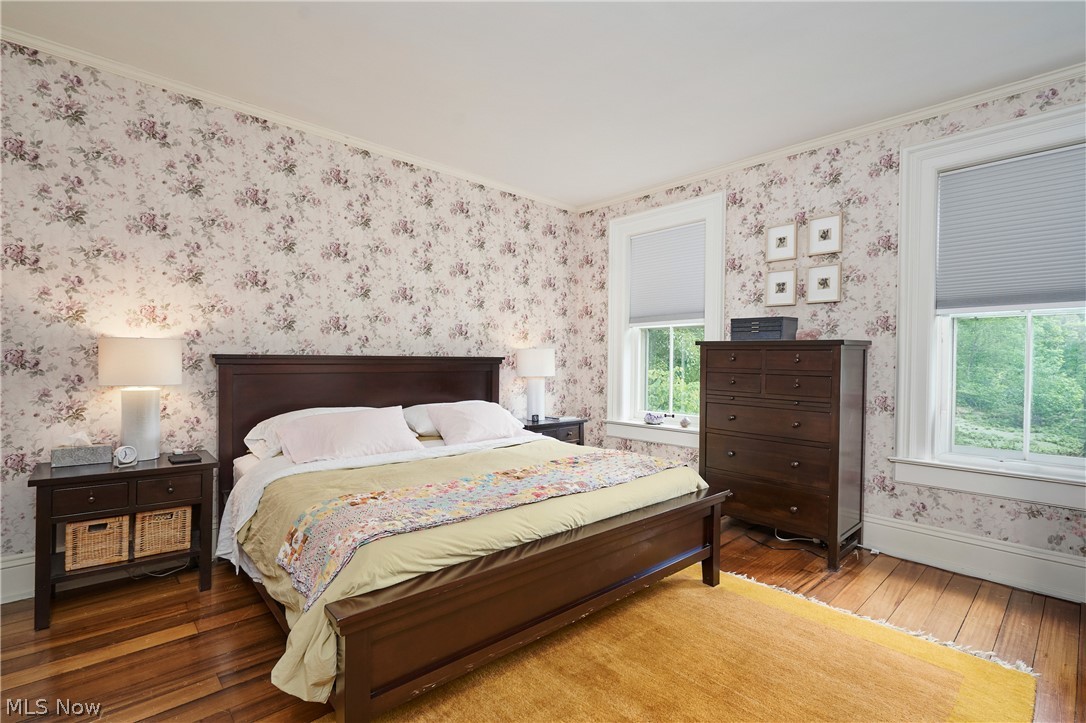 5046 Alger Road Richfield, OH 44286 - Photo 32 of 49 Hardwood flooring with a soft sheen underfoot, complemented by floral wallpaper and white trim