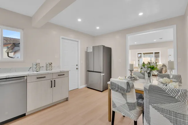 a kitchen with stainless steel appliances granite countertop a refrigerator and a sink