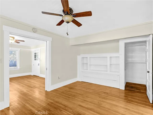 a view of empty room with wooden floor