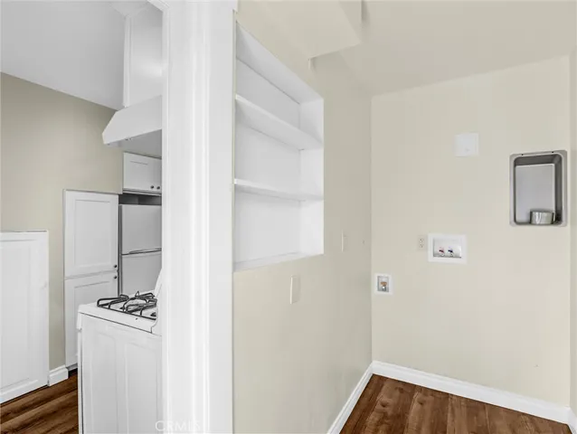a view of a hallway with wooden floor and closet