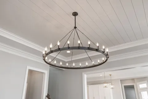 a room with wooden floor and staircase