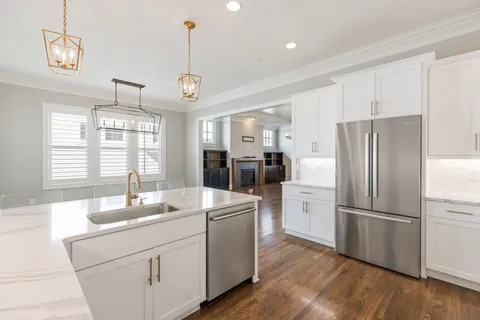a kitchen with stainless steel appliances a refrigerator sink and cabinets