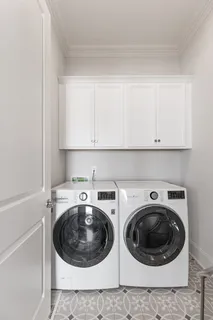 a utility room with sink dryer and washer