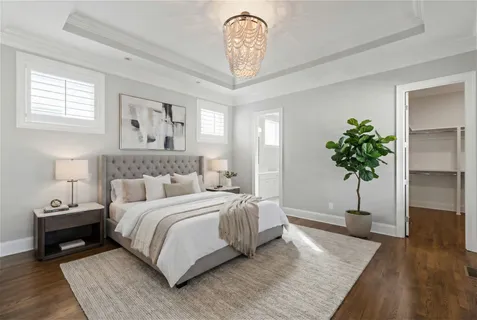 a bedroom with a bed and a potted plant