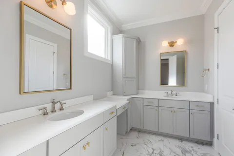 a bathroom with a double vanity sink mirror and