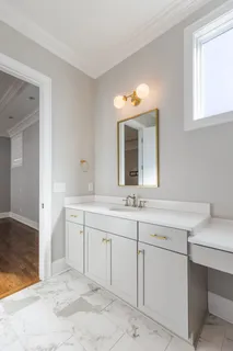 a spacious bathroom with a sink and a mirror