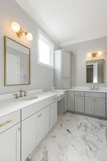 a bathroom with a sink vanity and mirror