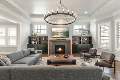 a living room with furniture a fireplace and windows