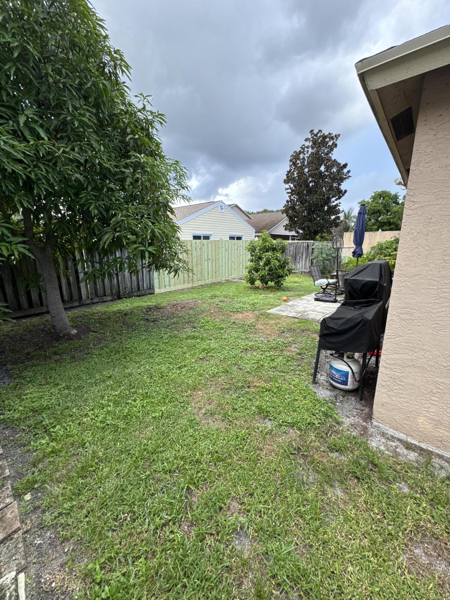 5621 Azalea Circle West Palm Beach, FL 33415 - Photo 1 of 20 a view of a backyard with a garden and entertaining space