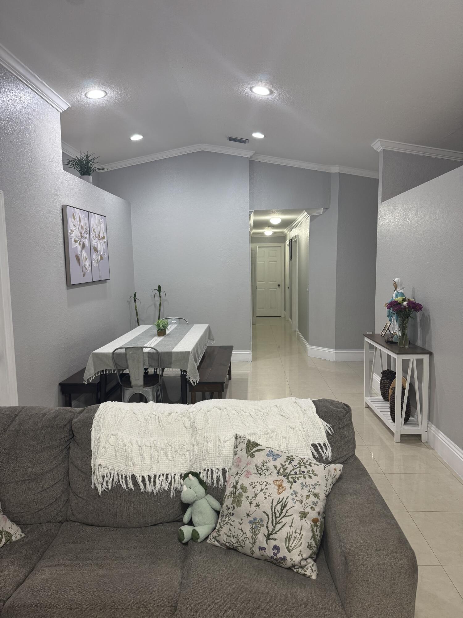 5621 Azalea Circle West Palm Beach, FL 33415 - Photo 12 of 20 a bedroom with a large bed and a chandelier