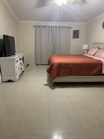 a bedroom with a bed and cabinet