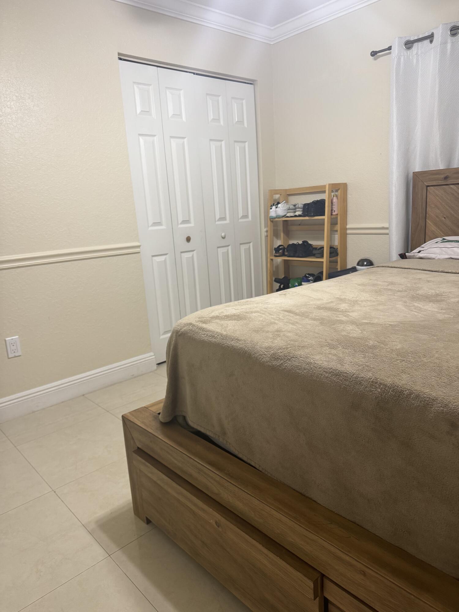 5621 Azalea Circle West Palm Beach, FL 33415 - Photo 17 of 20 a bedroom with a bed and cabinet
