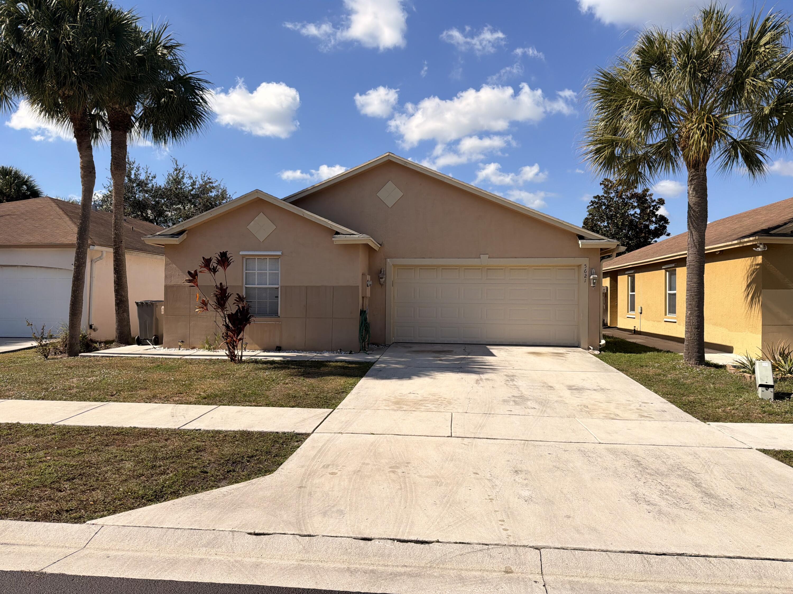 5621 Azalea Circle West Palm Beach, FL 33415 - Photo 2 of 20 a view of a house with a yard