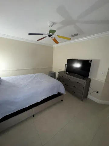 a bedroom with bed and window