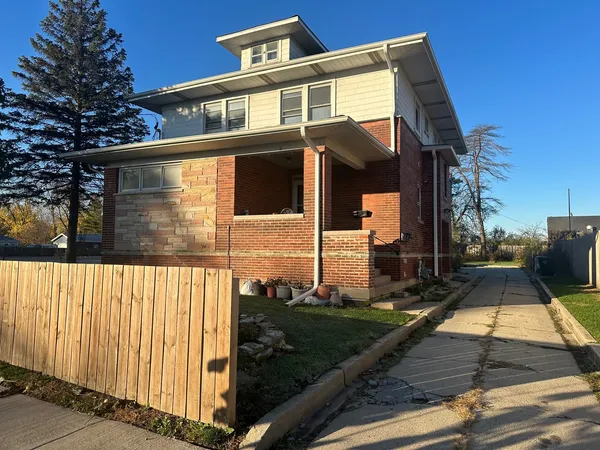 a view of a house with a wooden fence