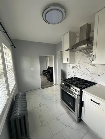 a kitchen with stainless steel appliances a stove a sink and a refrigerator