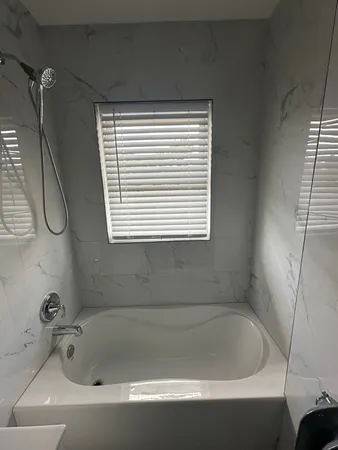 a bathroom with a bath tub and a window