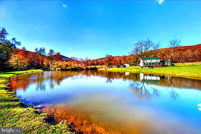 a view of a lake with houses in the back