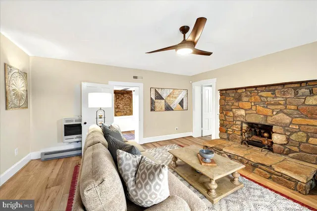 a view of a house with a big yard and large trees