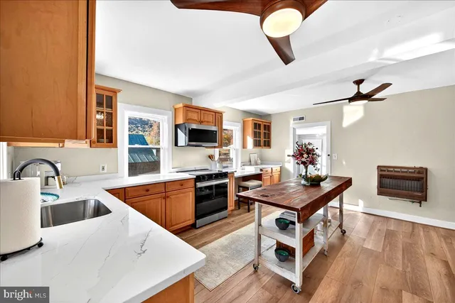 a view of a house with wooden deck and a ocean view