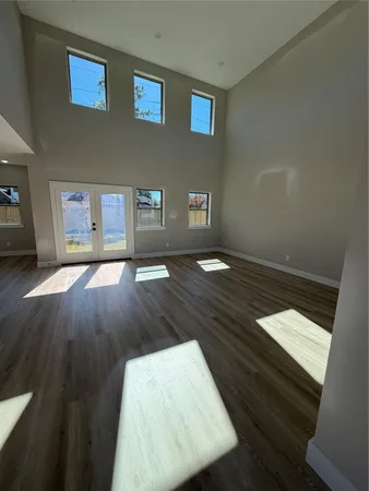 a large white kitchen with a large window