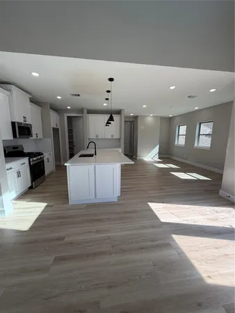 a view of a livingroom with wooden floor and stairs