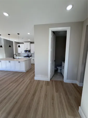 a view of a hallway with wooden floor and staircase