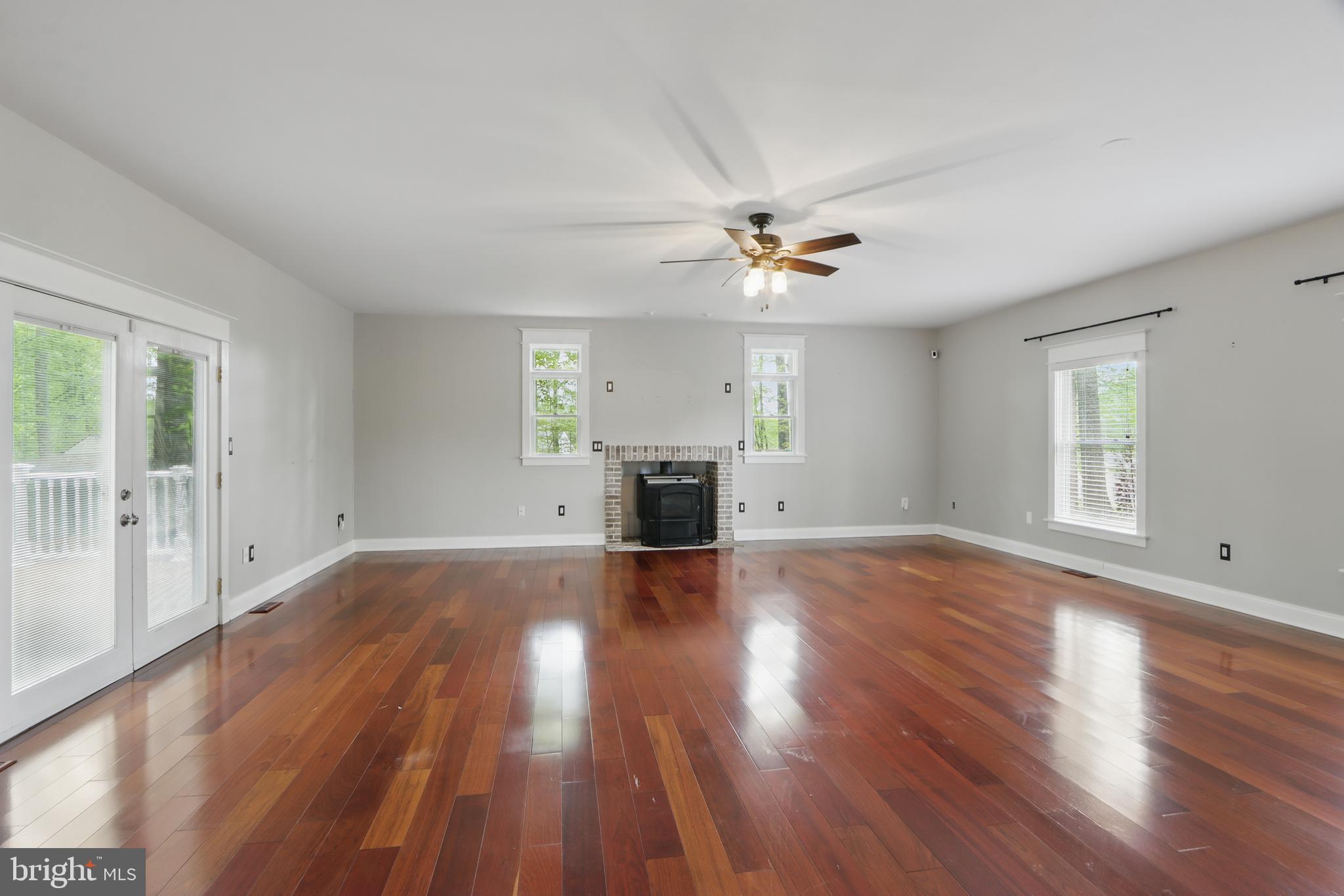 5185 Meadows Farm Road Lothian, MD 20711 - Photo 11 of 29 a view of empty room with wooden floor and fan