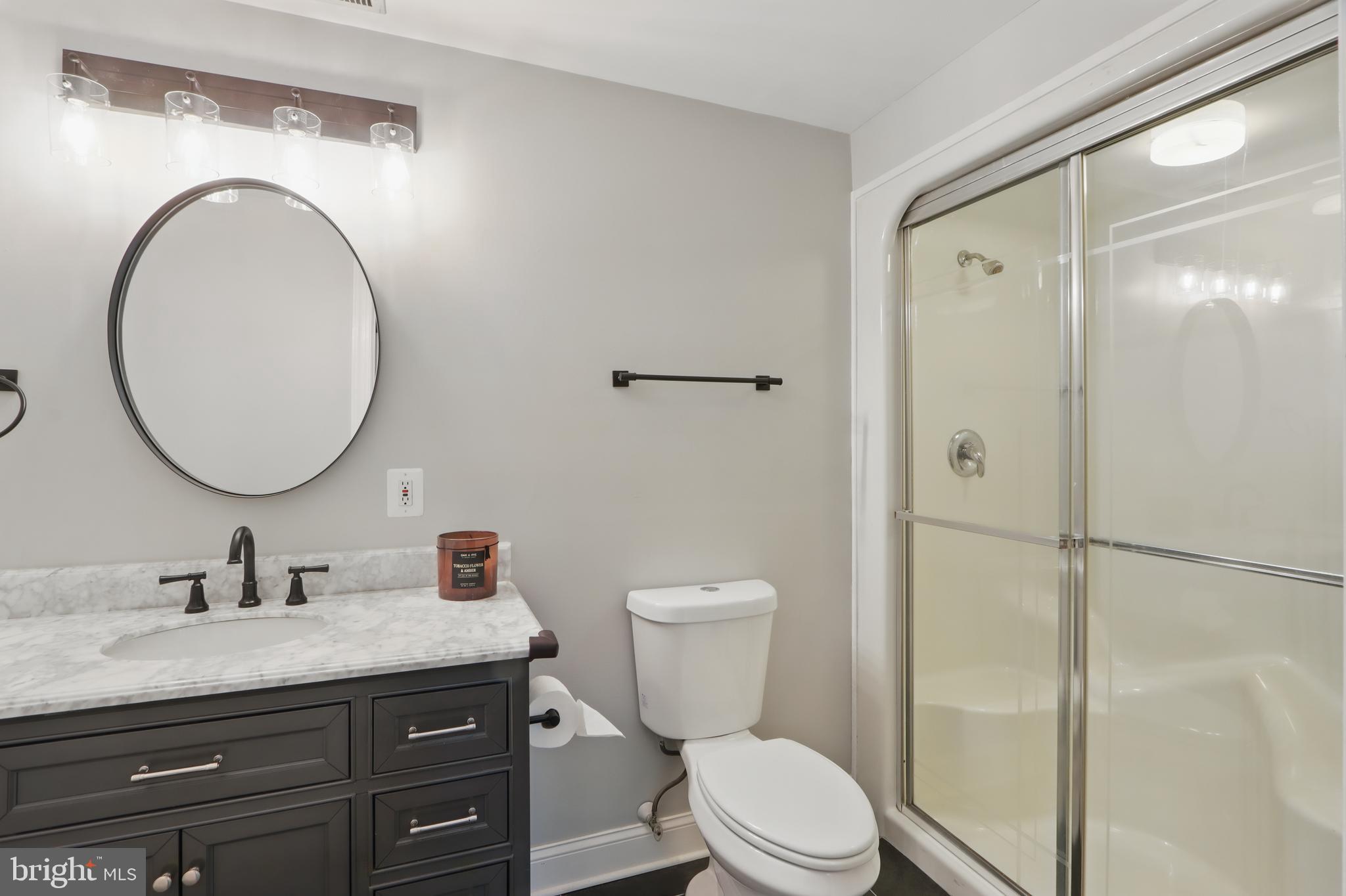 5185 Meadows Farm Road Lothian, MD 20711 - Photo 12 of 29 a bathroom with a granite countertop toilet sink and a mirror