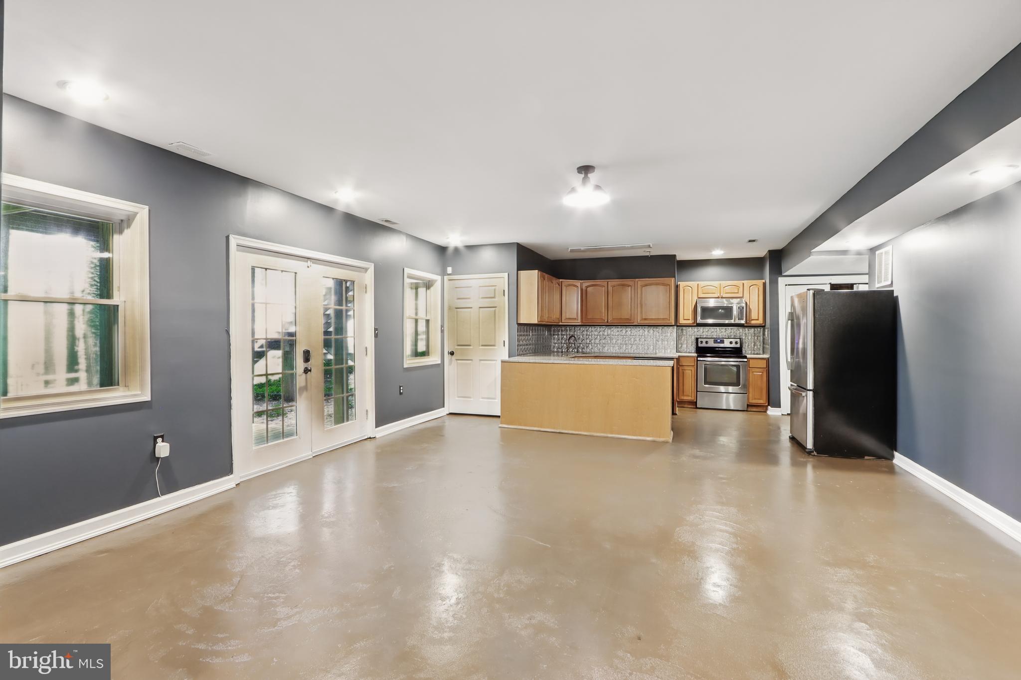 5185 Meadows Farm Road Lothian, MD 20711 - Photo 13 of 29 a view of a electric appliances in kitchen and empty room with wooden floor