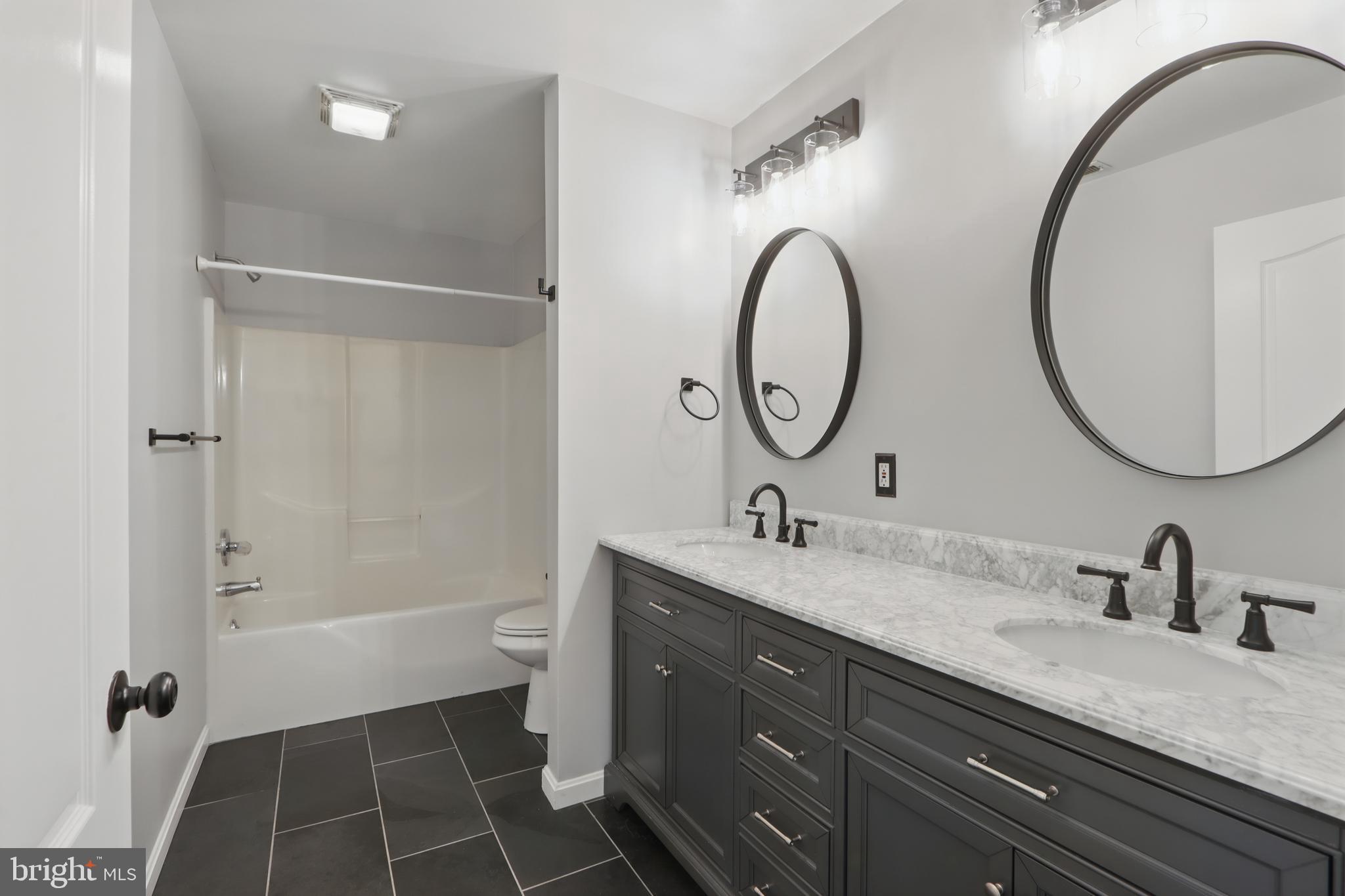 5185 Meadows Farm Road Lothian, MD 20711 - Photo 23 of 29 a bathroom with a sink and a mirror