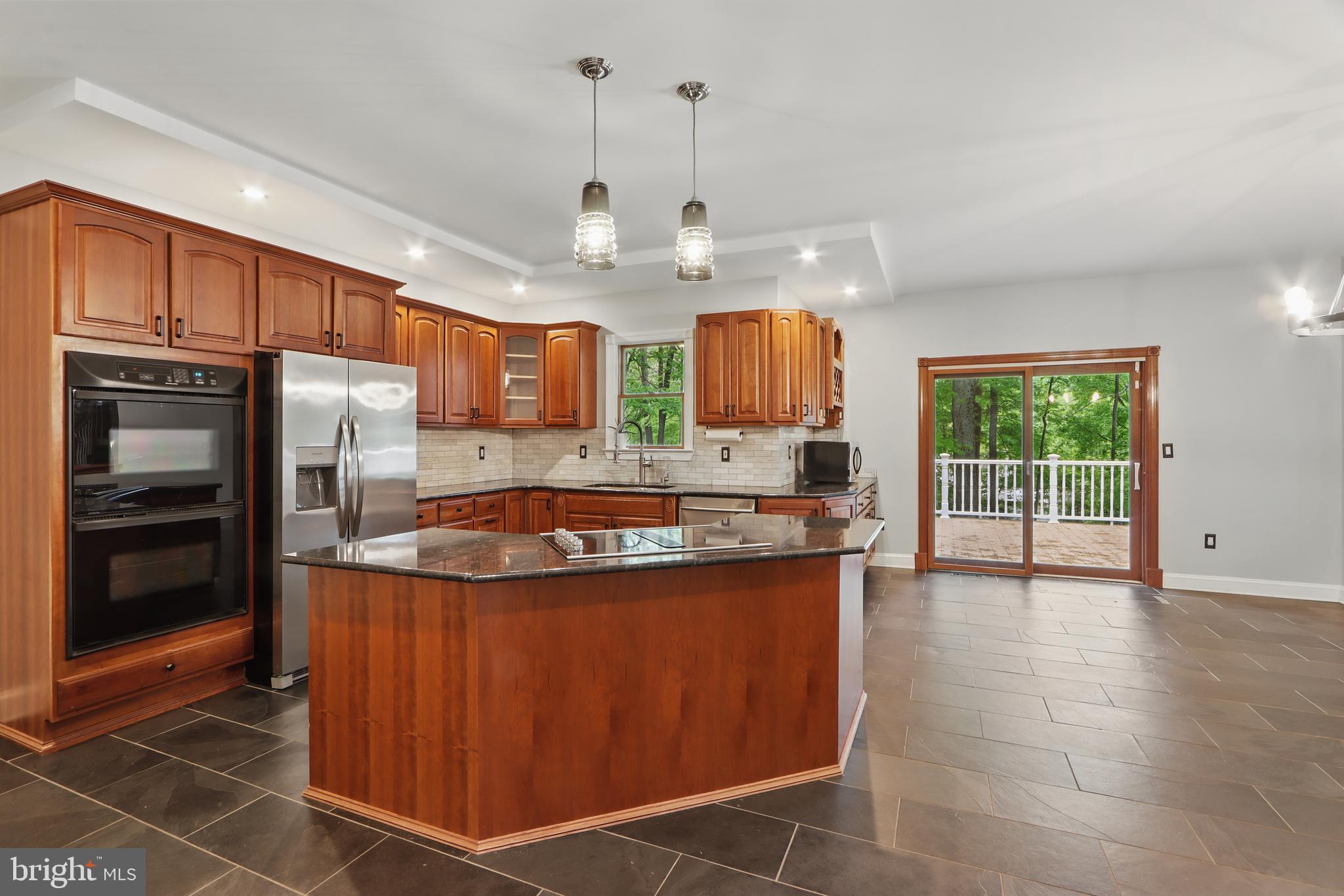 5185 Meadows Farm Road Lothian, MD 20711 - Photo 8 of 29 a large kitchen with stainless steel appliances granite countertop a stove a sink and a refrigerator