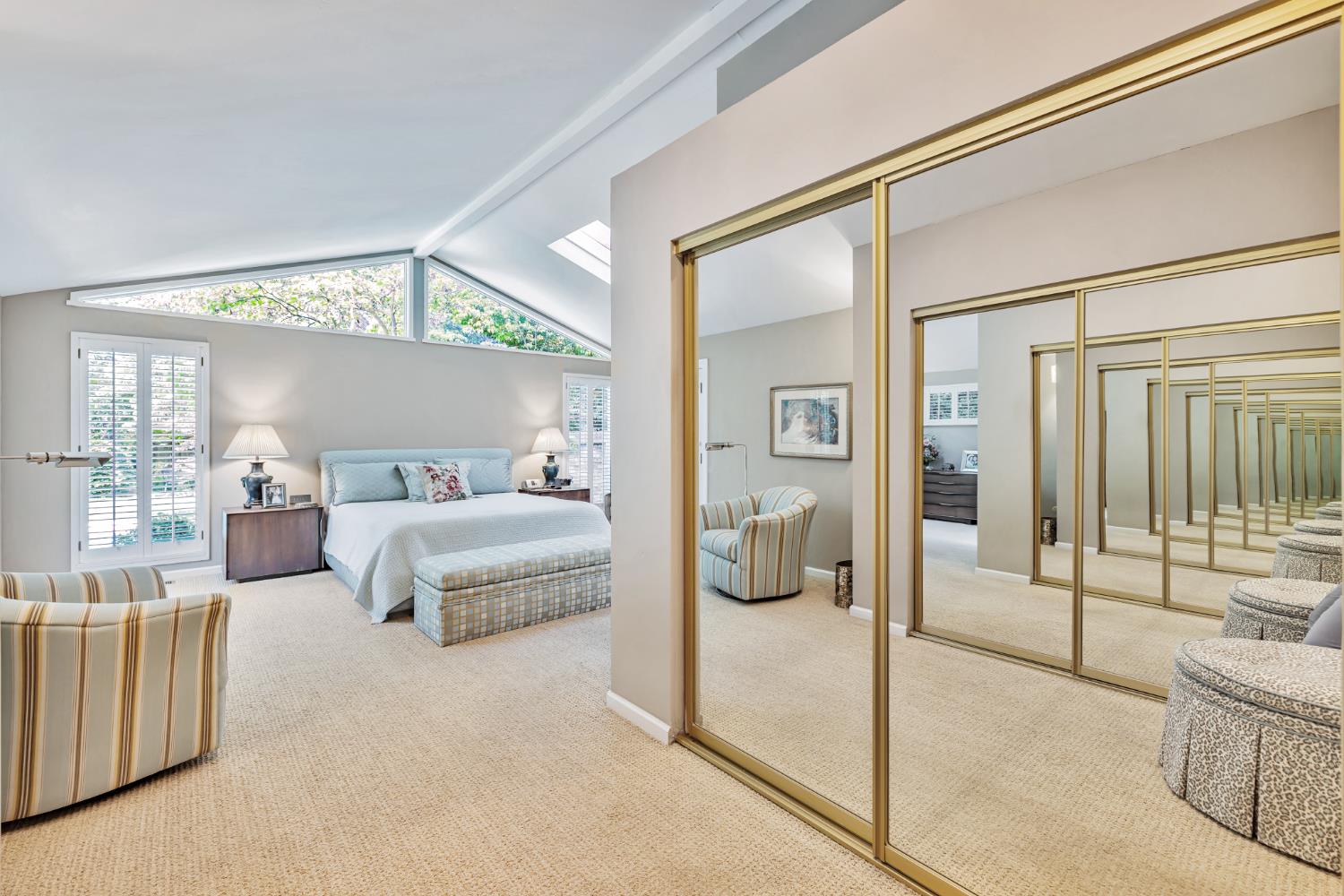 1625 Gary Way Carmichael, CA 95608 - Photo 14 of 49 a spacious bedroom with a large bed and a chandelier