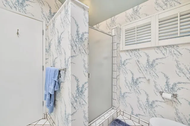 a bathroom with a shower and a shower curtain